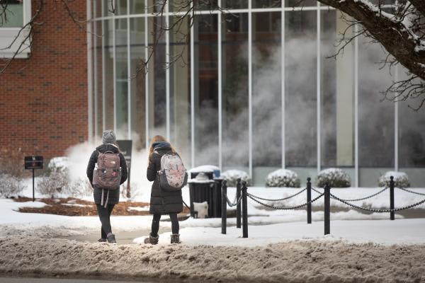 Students walk in the snow on campus