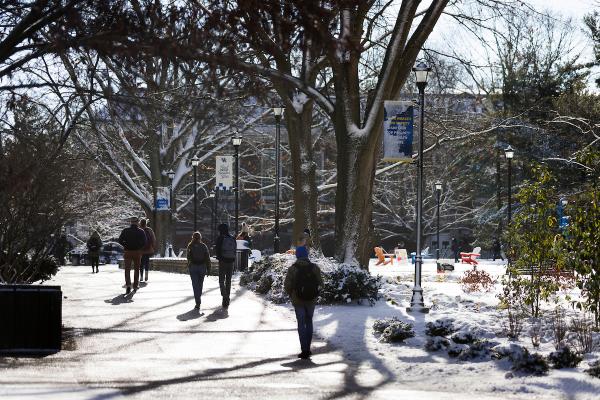 Photo of students walking through campus in the winter
