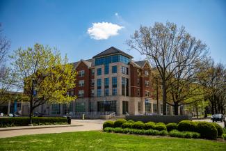 View of Lewis Hall through trees