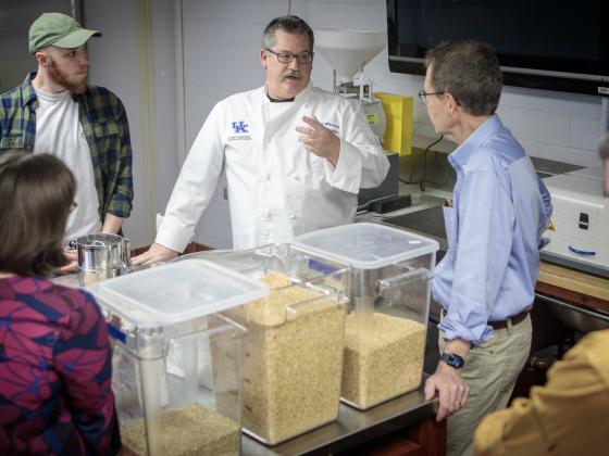 Dr. Bob Perry discussed the new stone mill with William Burgess and wheat researcher Dr. Dave Van Sanford in the Foods Lab.